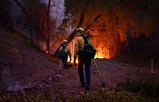 Firefighters race to beat LA blazes as winds grow and death toll hits 16