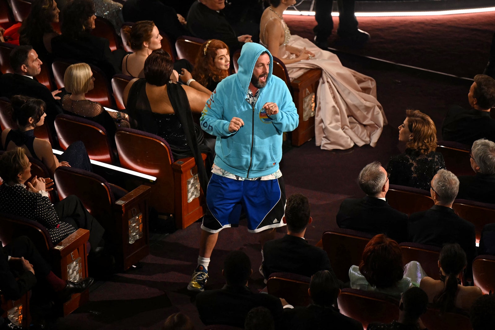 Image may contain Adam Sandler Madge Gill Slash People Person Clothing Footwear Shoe Crowd Adult and Child