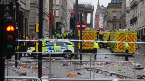 PA Media Police and emergency personnel dealing with an incident near the Liver Building in Liverpool during the Premier League winners' victory parade on 26 May 2025.