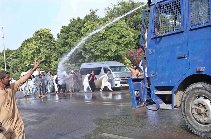 Police use water cannon to disperse protesters belonging to Sindh Employees Association outside the Press Club.