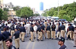 Police use water cannon to disperse protesters belonging to Sindh Employees Association outside the Press Club.