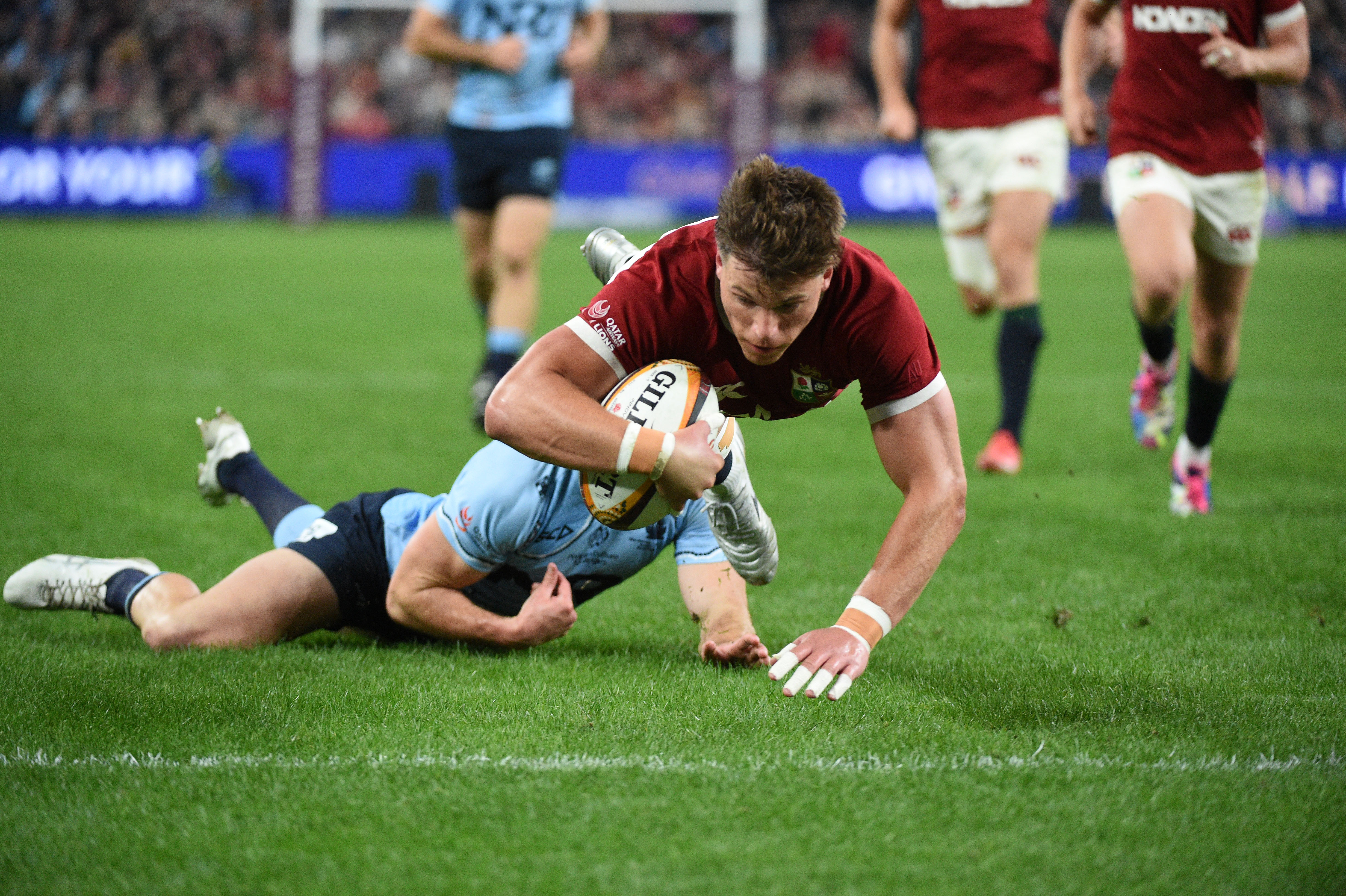 Huw Jones scoring a try for the British & Irish Lions.