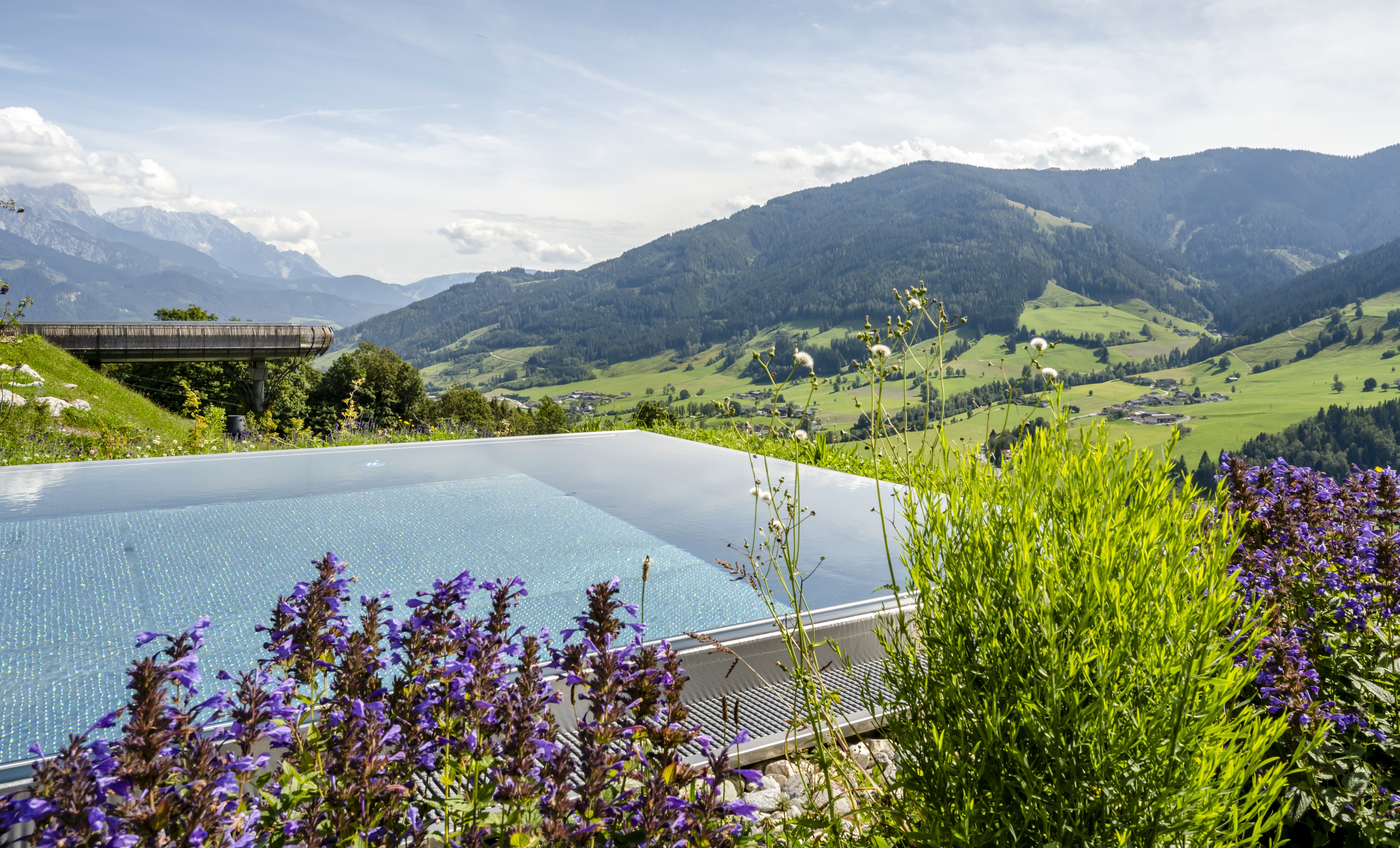 Infinity pool overlooking Austrian mountains.