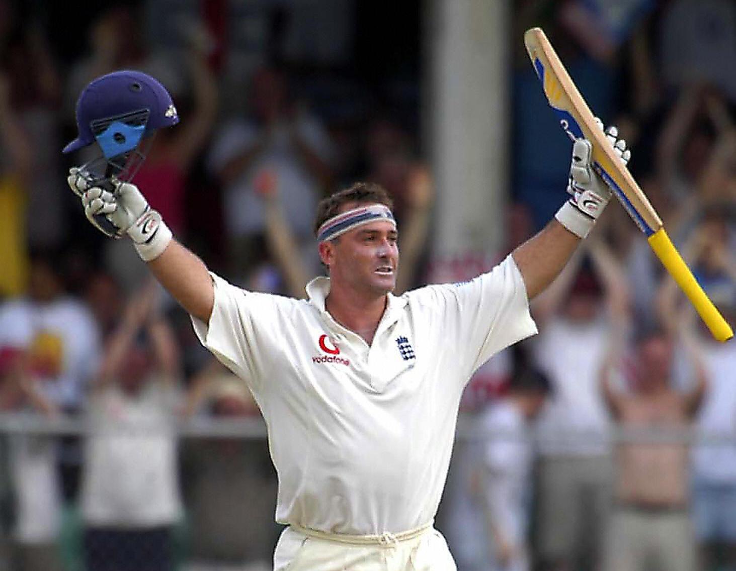 Thorpe, with his trademark headband on, raises his bat in celebration of his century at The Kensington Oval against West Indies in 2004