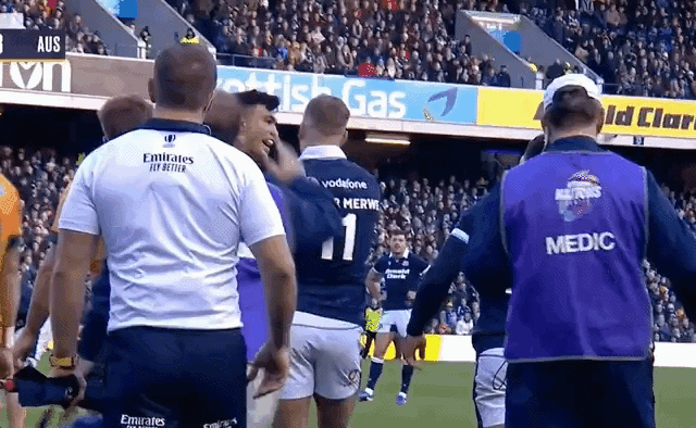 Rugby players interacting on the field.