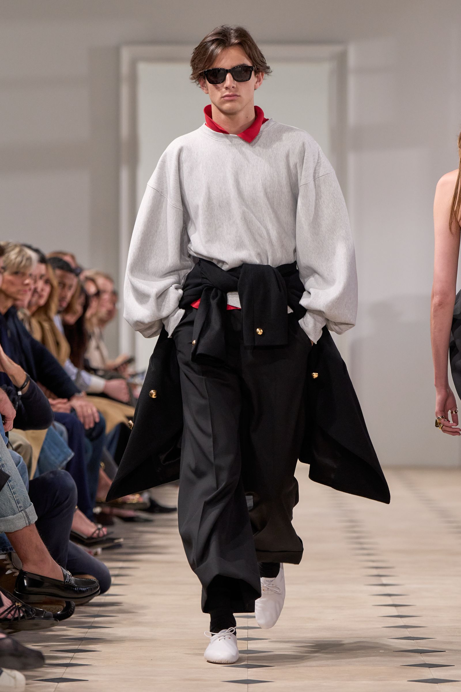 Image may contain Fashion Clothing Pants Person Accessories Glasses Footwear Shoe Cape Adult Coat and Long Sleeve