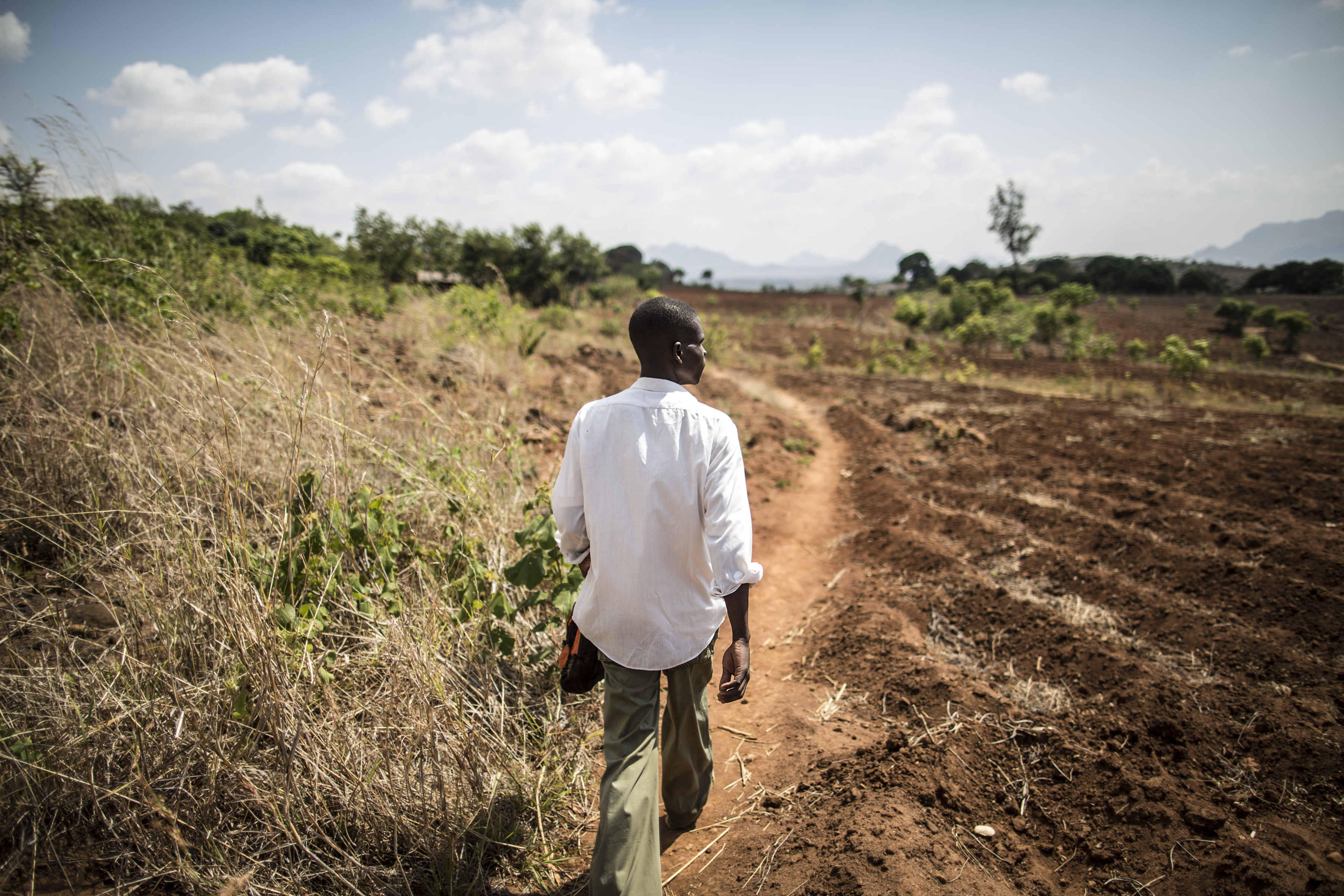 Frank Pancha Chisel walks in 2014 to the Mikolongwe health centre, three hours from his village, to get a month’s worth of ARV therapy for himself and the other five members of his group of patients.