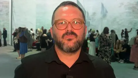 Mathieu St-Arnaud Mathieu St-Arnaud has short receding brown hair with a brown beard specked with grey and large caramel-coloured spectacles.