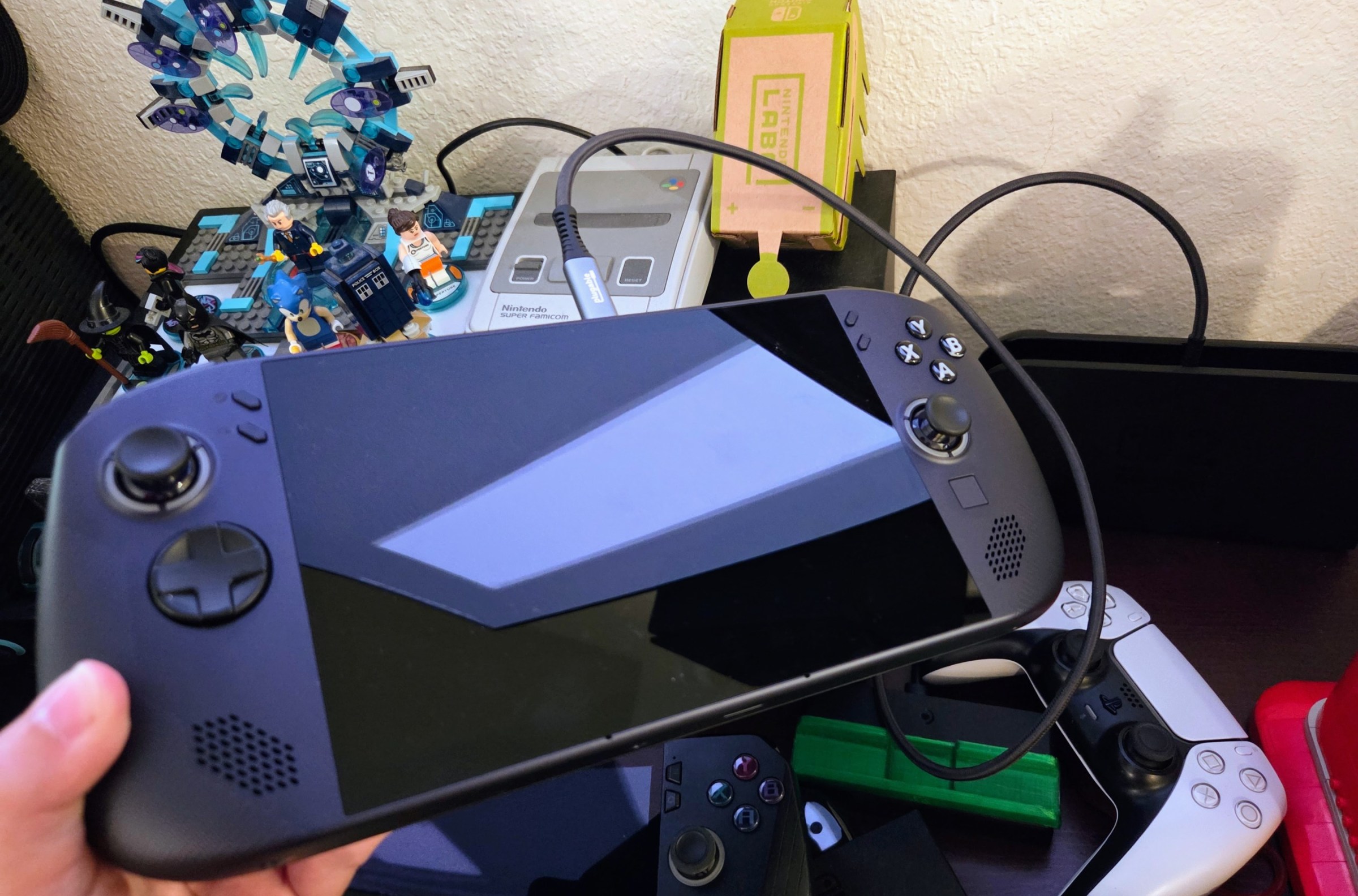 A Legion Go S with SteamOS plugged into the Switch 2 dock with a USB-C extension.