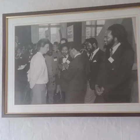 Leon Leiffer Photo of a black and white photo inside a frame of Princess Anne meeting various members of Brafa who are wearing suits