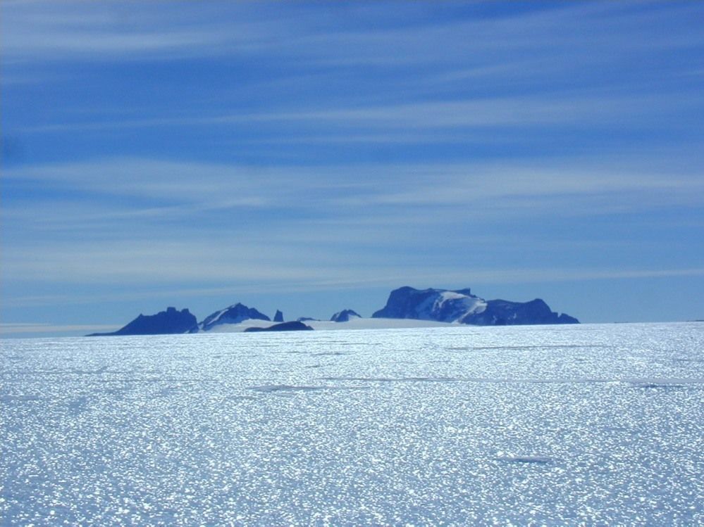 Martian meteorite Yamato 000593 was discovered on the 2-kilometer-thick sheet of blue ice that surrounds the Yamato Mountains.  The first nine meteorites discovered by Japanese explorers in 1969 were also found here. (Courtesy the National Institute of Polar Research)