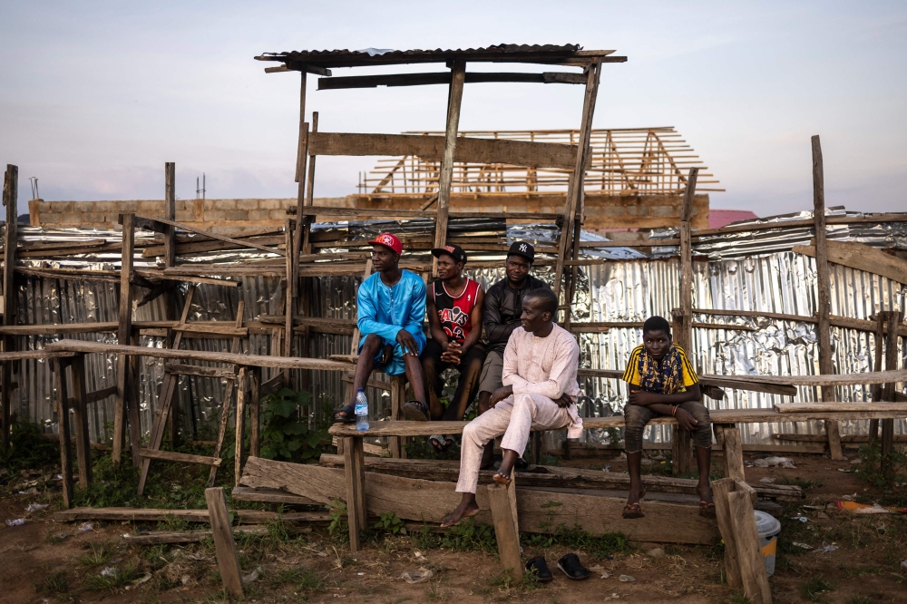 Spectators sit on wooden bleaches during a Dambe event in the Dei-Dei neighbourhood in Abuja, on June 27, 2025. — AFP pic