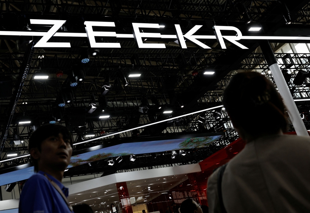 Visitors walk past the Zeekr logo, at the Beijing International Automotive Exhibition, or Auto China 2024, in Beijing April 25, 2024. — Reuters pic  