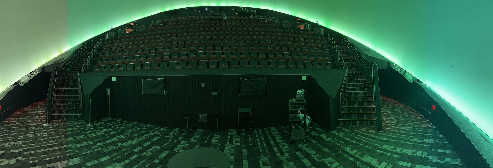 Rows of seats next to a green screen