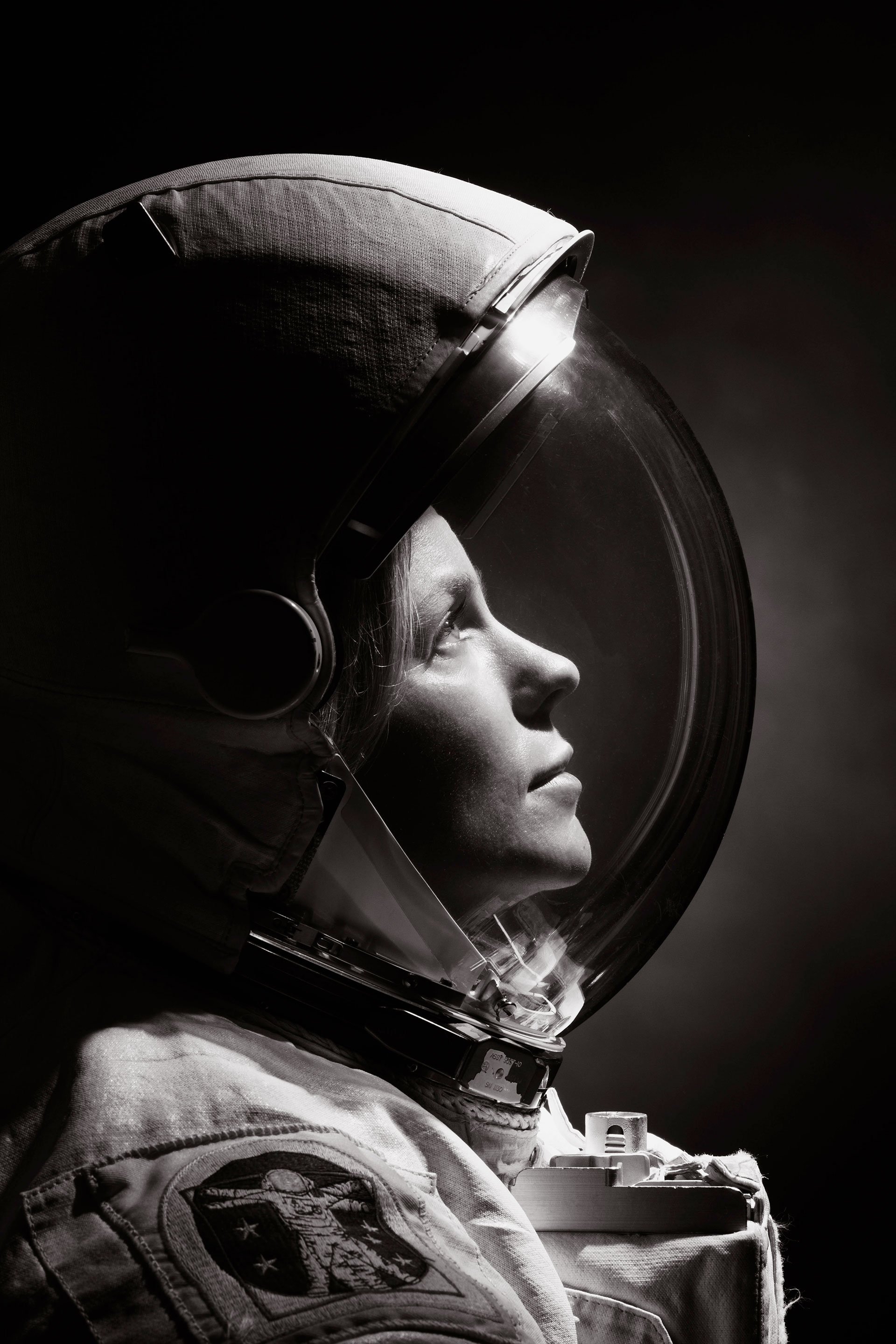 a black and white profile portrait of NASA astronaut Zena Cardman wearing a spacesuit.