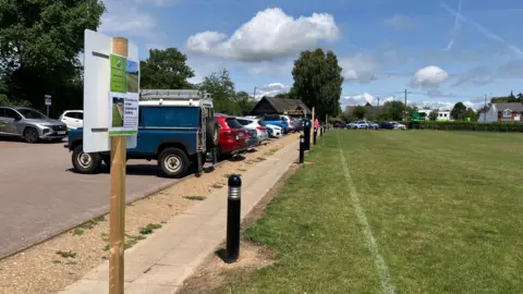 Matt Knight/BBC A general view of the edge of the cricket field's boundary at Dawson Fields and the adjacent public car park.