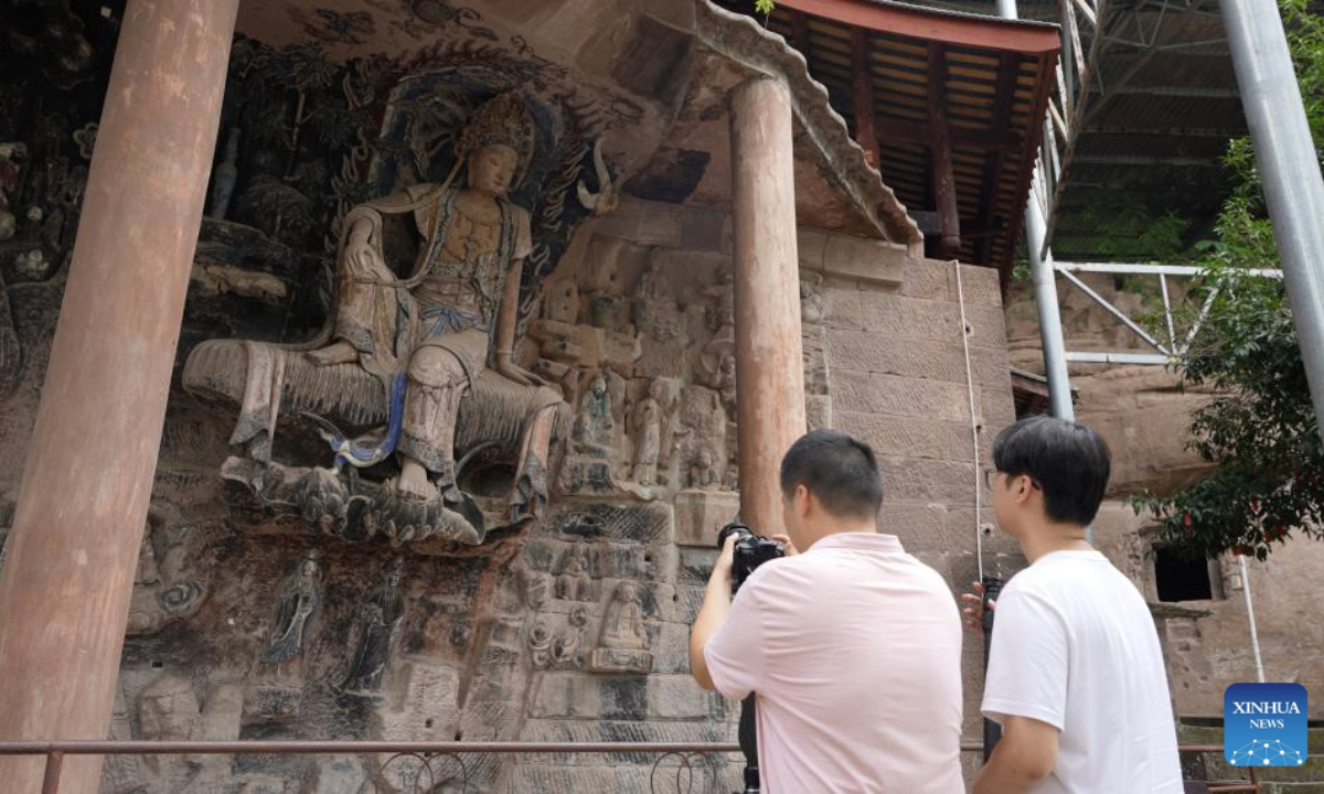 This undated photo shows employees of Leenzee Games scanning stone carvings in Anyue County, southwest China's Sichuan Province. (Leenzee Games/Handout via Xinhua)