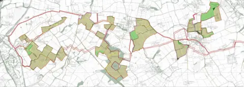 A mainly white map showing roads and the boundaries of fields, with areas in green to show where solar panels will be built. 