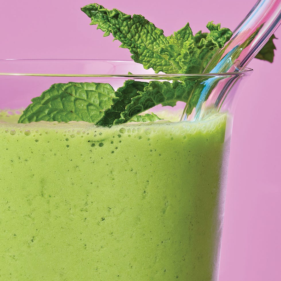 green smoothie in front of purple pink background