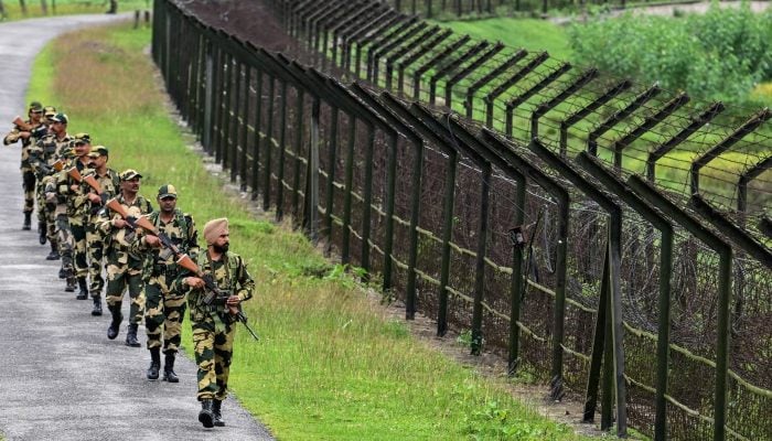 Border Security Force personnel patrol along the border with Bangladesh in Golakganj, Assam, India. — AFP