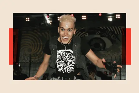 Getty Images Pete Bennett smiles - he wears a black outfit and has short bleached blonde hair