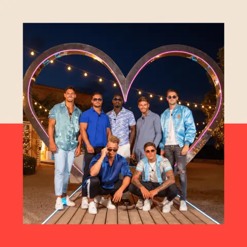 ITV/PA Wire Seven Love Island contestants pose in front of a giant heart icon