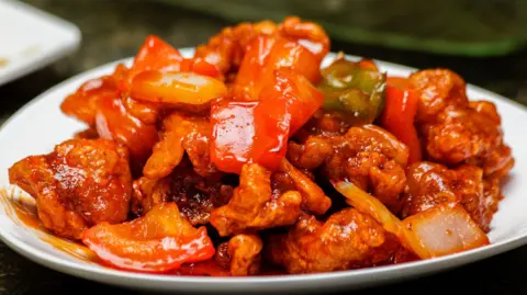 Getty Images Stock photo of sweet and sour chicken with green and red chilli peppers.