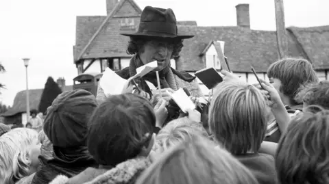 BBC Tom Baker signs autographs for young fans during a break in filming for The Android Invasion.