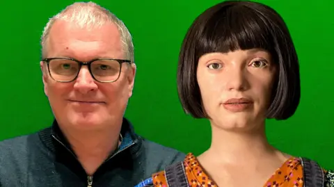 Copyright 2025 © Ai-Da Robot Studios Ai-Da and her creator Aidan Meller photographed in front of a green canvas.