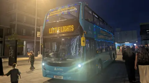 BBC / David North A double decker bus has the words 'Liverpool's Zoe's Place is becoming Little Lights' written on it, with 'Little Lights' on the vehicle's destination screen.