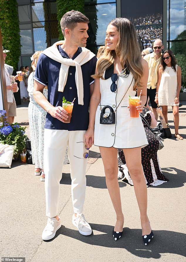 Union J star Josh Cuthbert and and his model wife Chloe Lloyd, who were also in the stands, with Chloe wowing in a white mini dress as they sipped on Pimm's