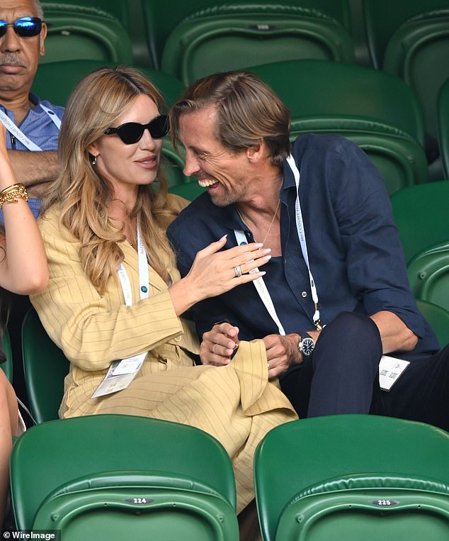 Peter laughed after Abbey Clancy catches him cleaning his sunglasses on her dress