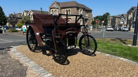A metal model of the Stephens car, sitting on a roundabout