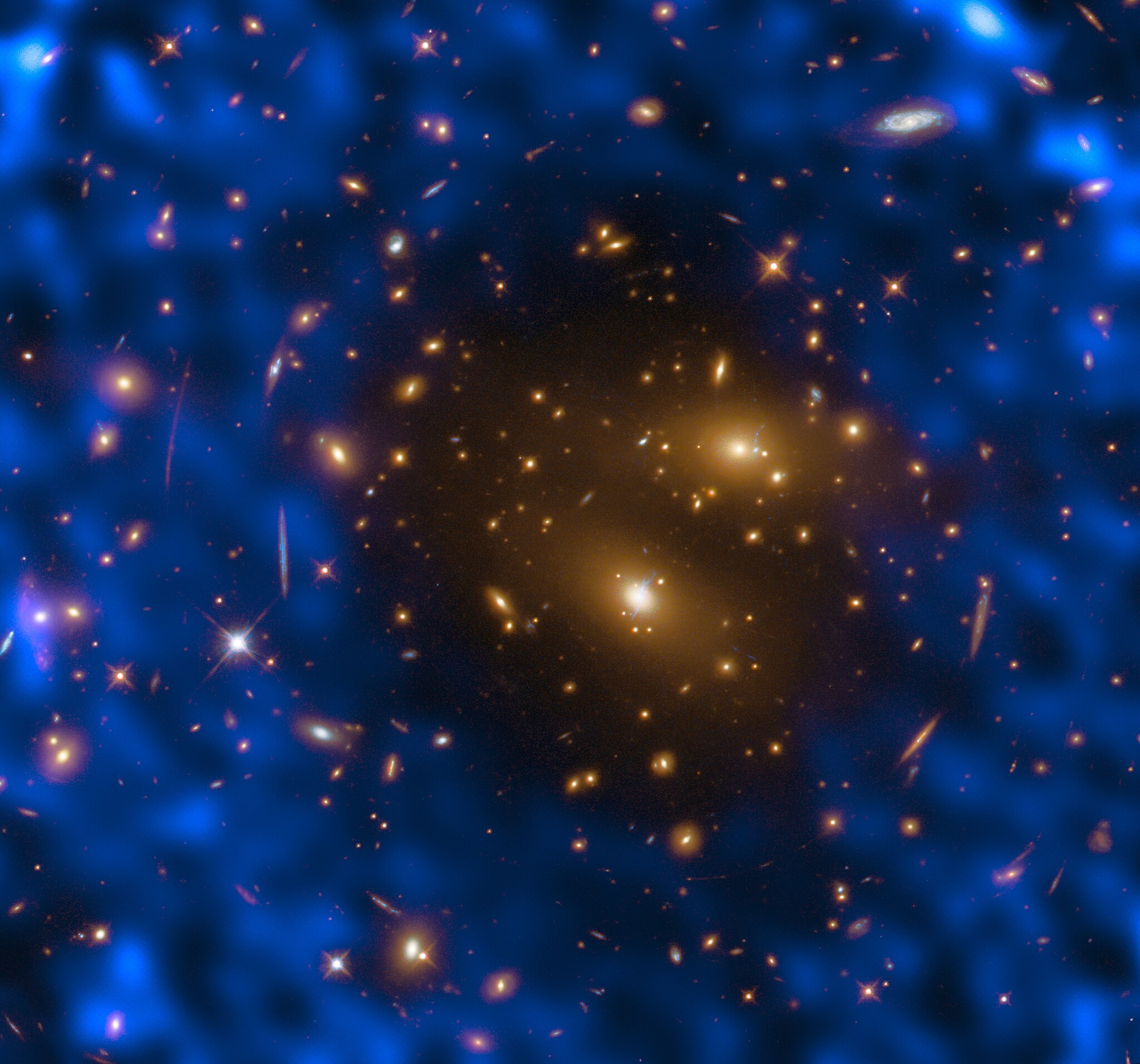 A swirl of blue clouds with dots of yellow sits on a dark background