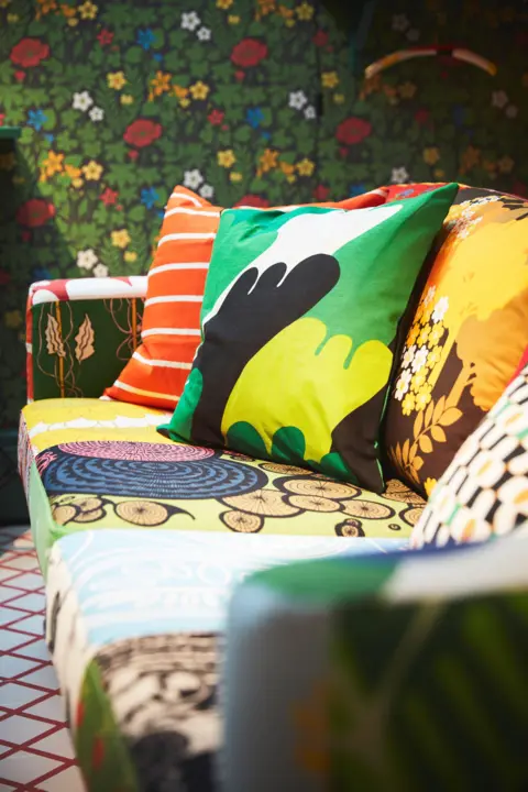 Ikea museum A close-up of a colourful sofa in a room full of patterns.