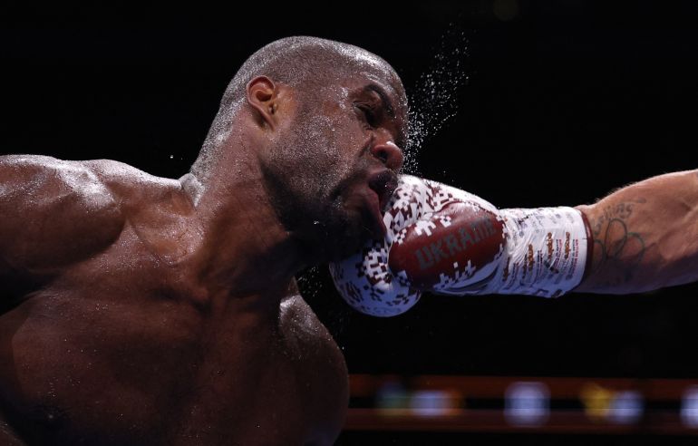 Britain's Daniel Dubois takes a punch from Ukraine's Oleksandr Usyk