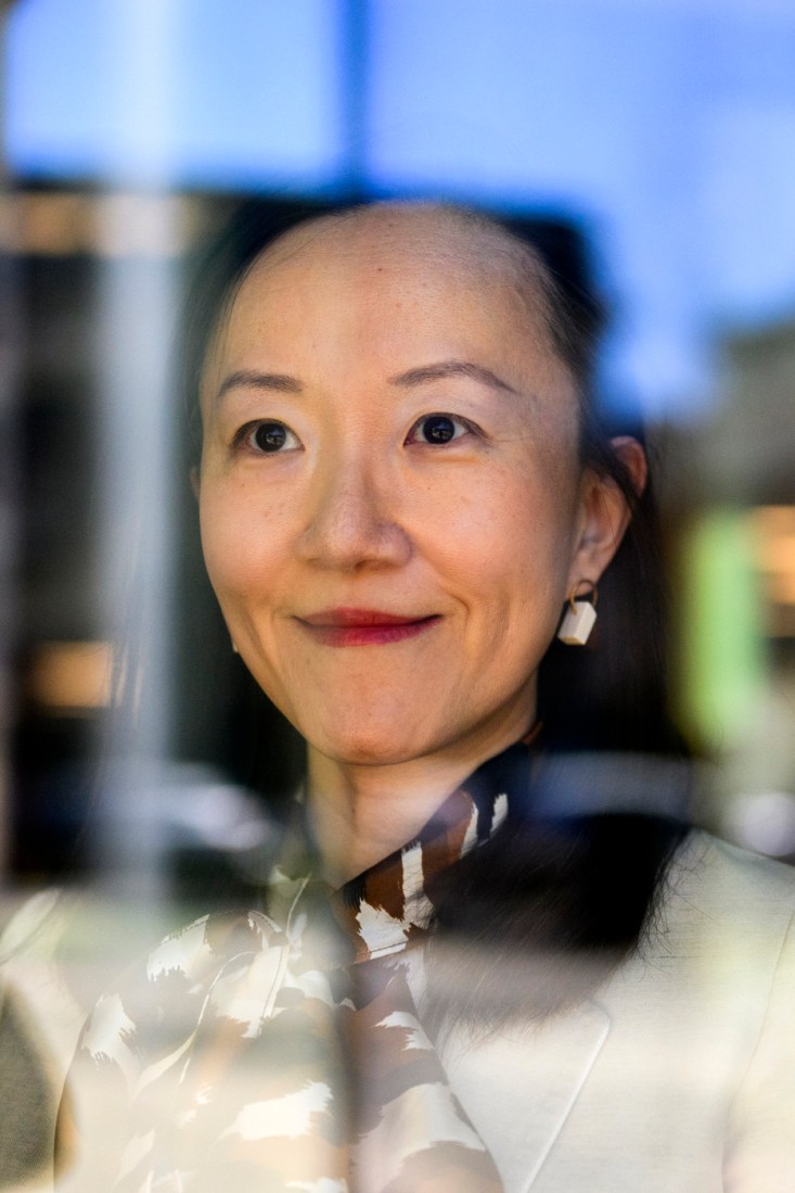 Portrait of Amy Lu, wearing a printed scarf and red lipsticks. 