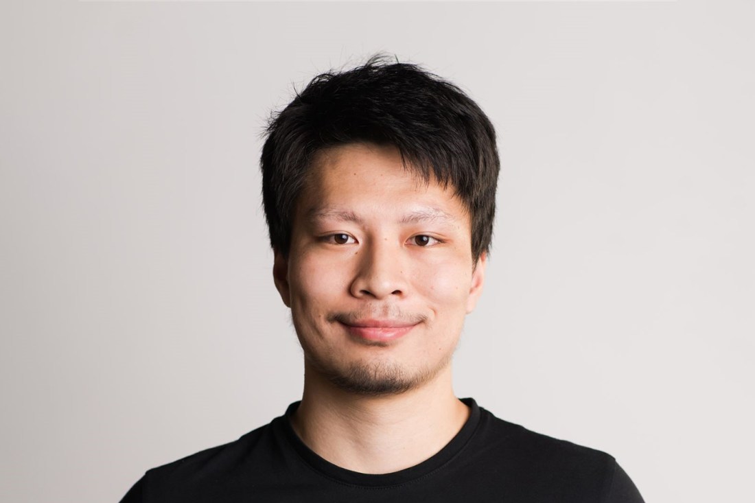 Portrait of Anran Lyu wearing a black shirt on a white background.