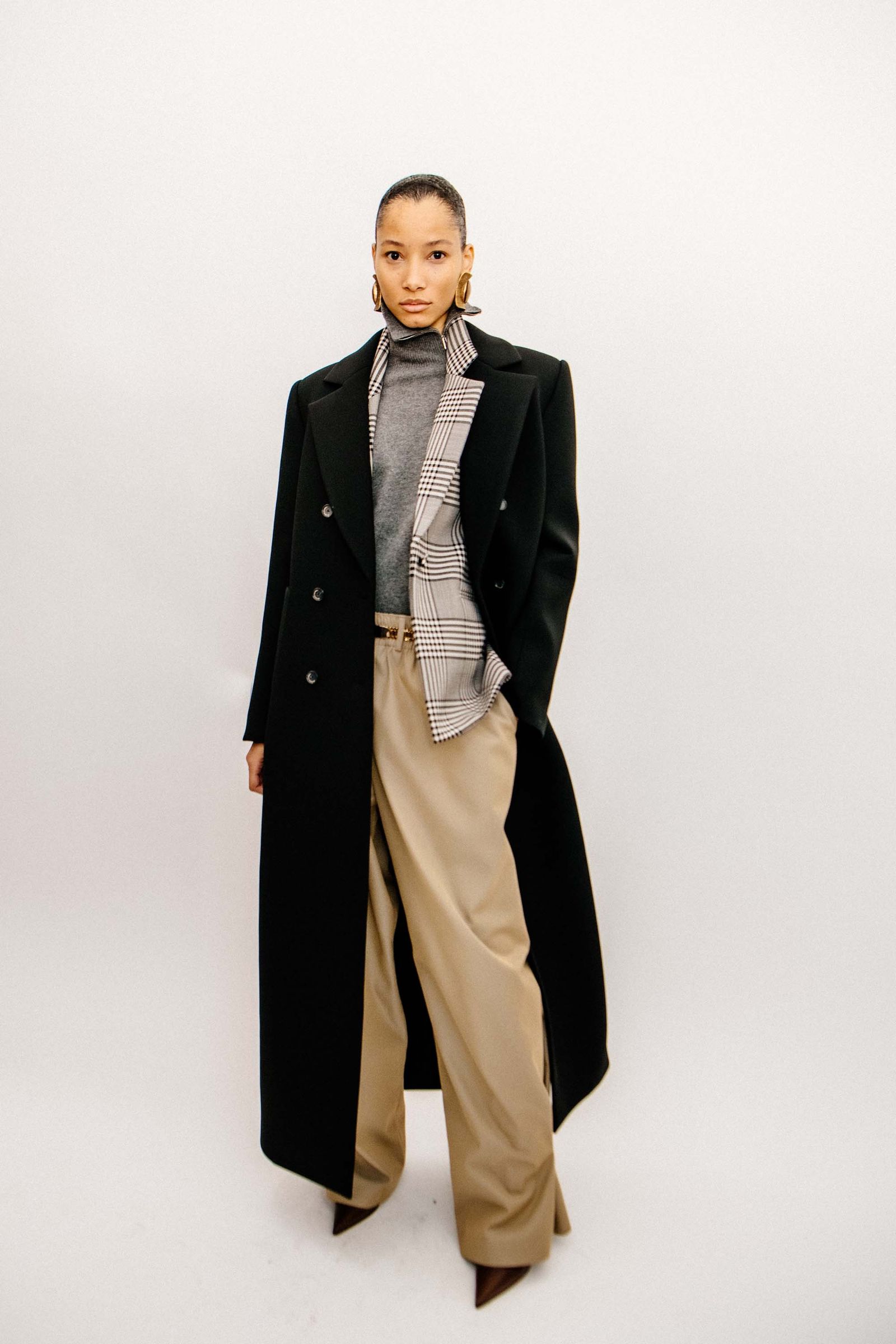 Image may contain Clothing Coat Overcoat Adult Person Long Sleeve Sleeve and Trench Coat
