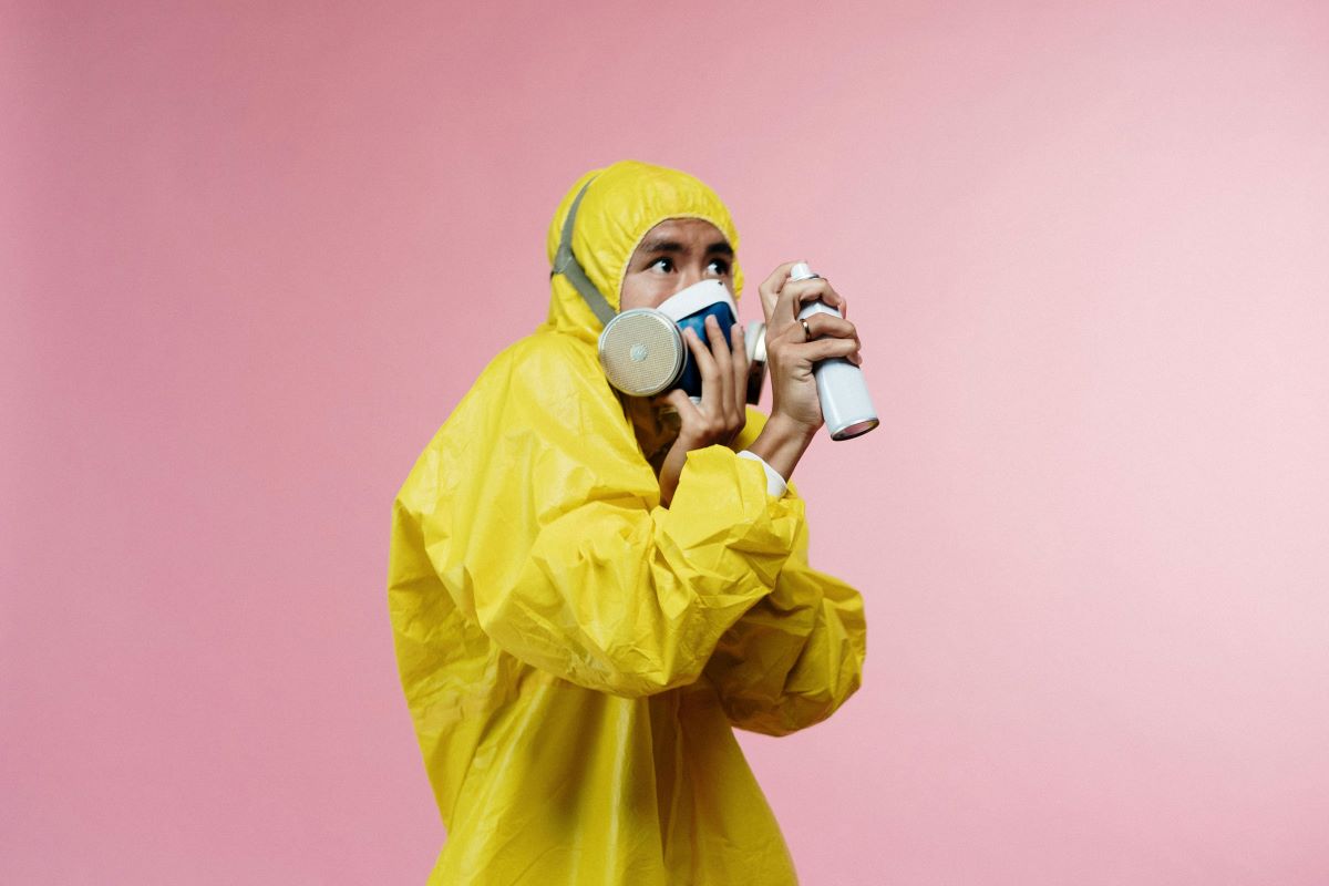 A person cleaning in a mask