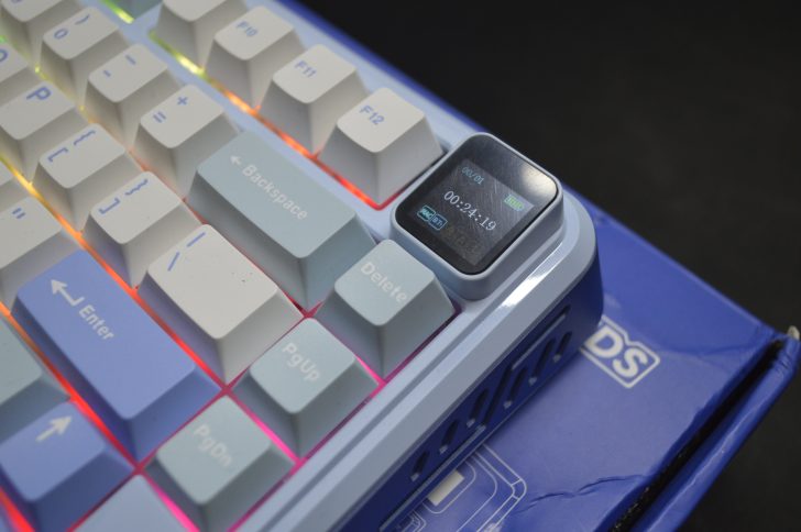 Colorful mechanical keyboard with digital screen feature on top-right key corner.