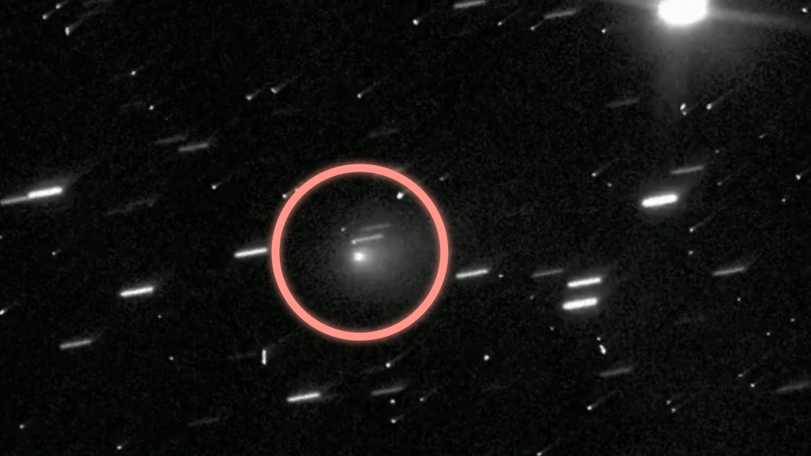 A red circle is around a fuzzy white dot. There are other fuzzy streams all around.