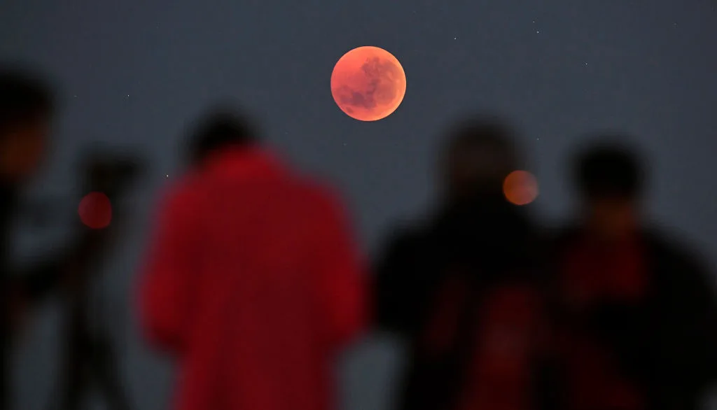 Observing a lunar eclipse can be done with the naked eye, as it's perfectly safe to do so. Photo by William West/AFP via Getty Images