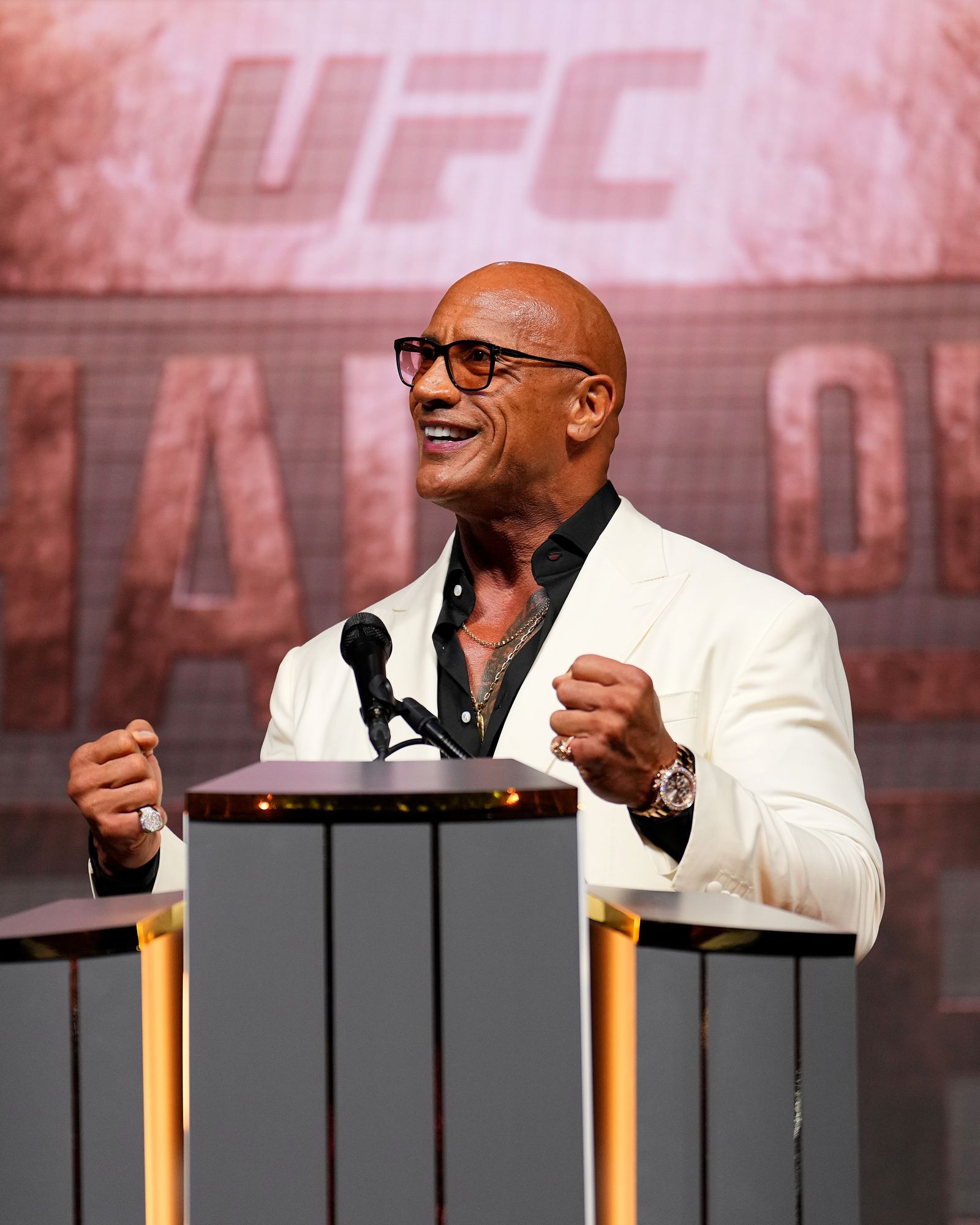 Image may contain Dwayne Johnson Crowd Person Electrical Device Microphone Wristwatch Accessories and Glasses