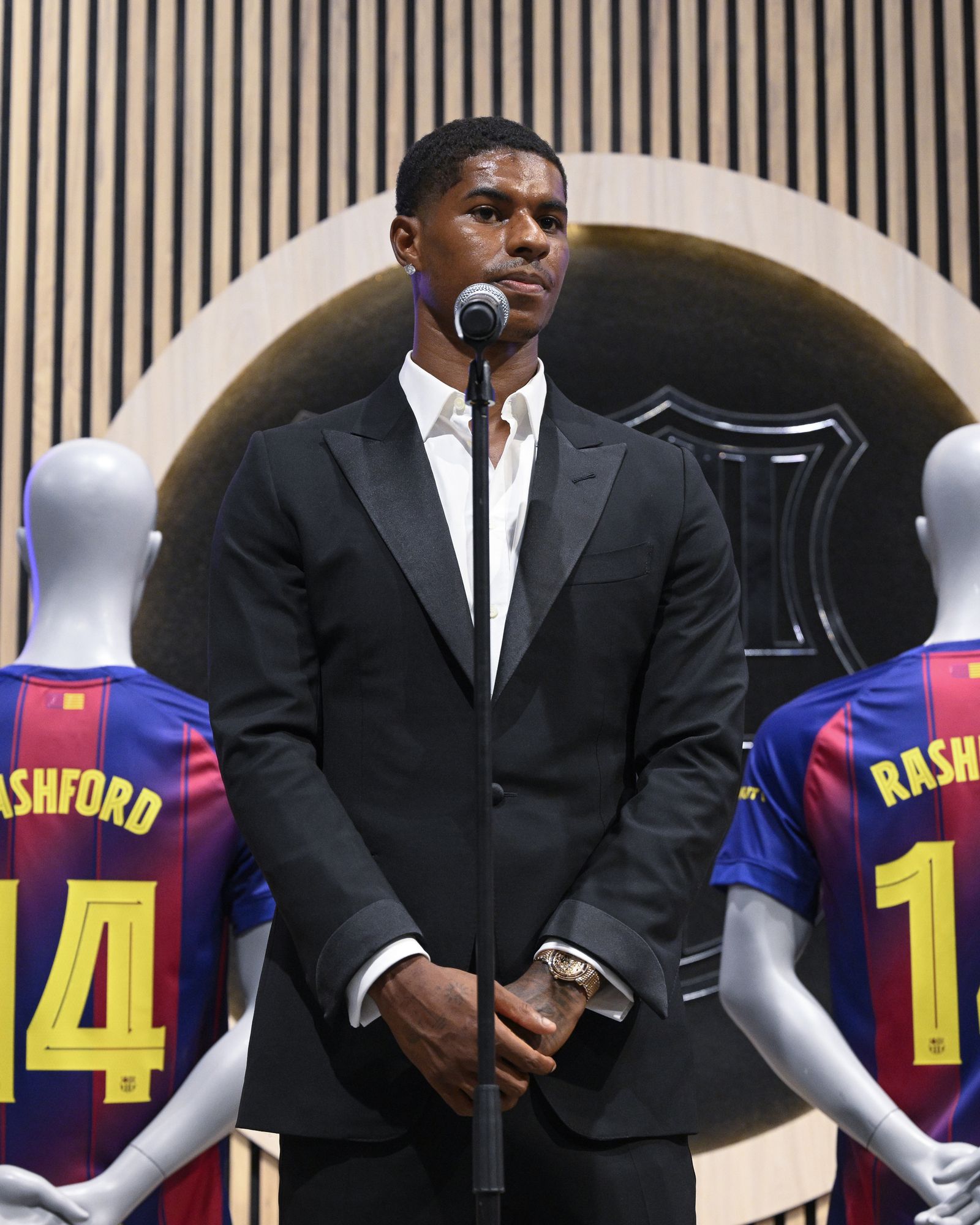 Image may contain Marcus Rashford Electrical Device Microphone Adult Person Wristwatch Blazer Clothing and Coat