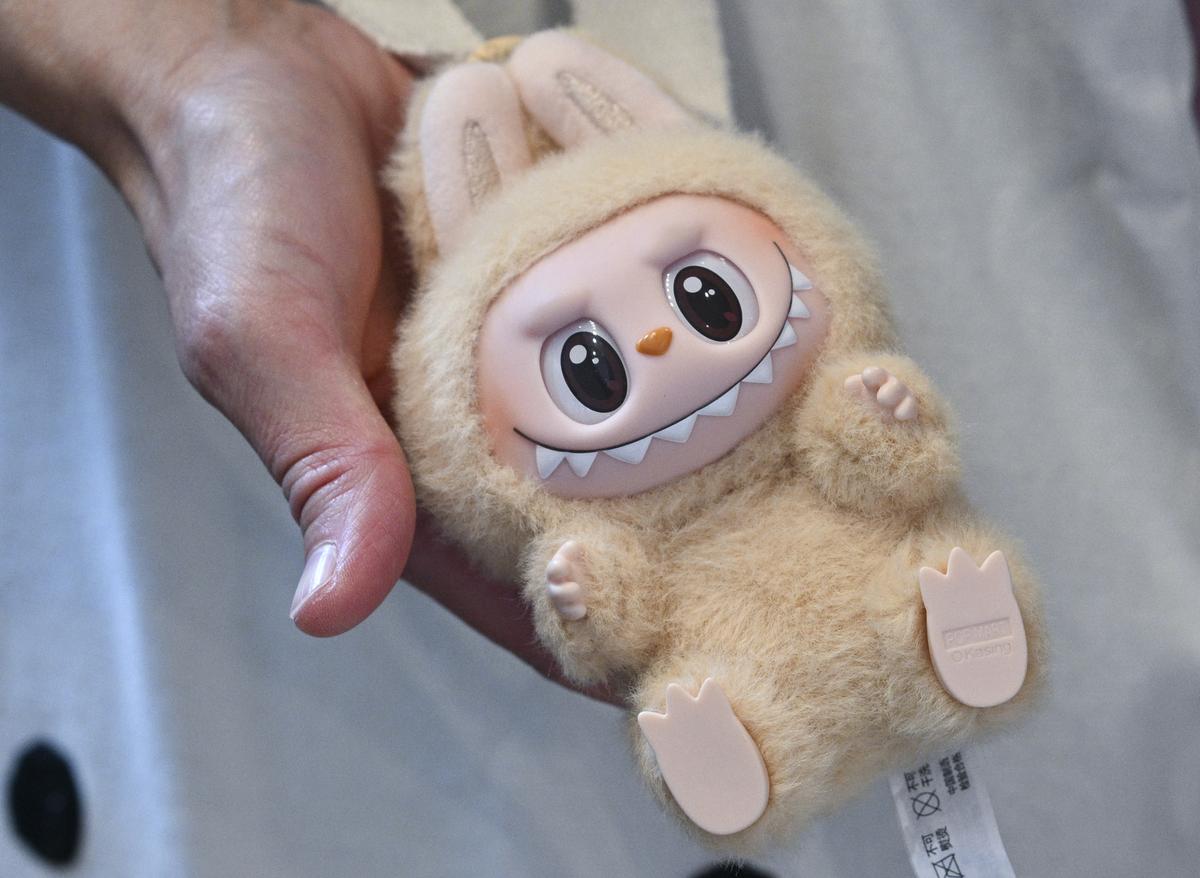 A woman holds a Labubu plush figure at the opening of Germany’s first Labubu store A woman holds a Labubu plush figure at the opening of Germany’s first Labubu store