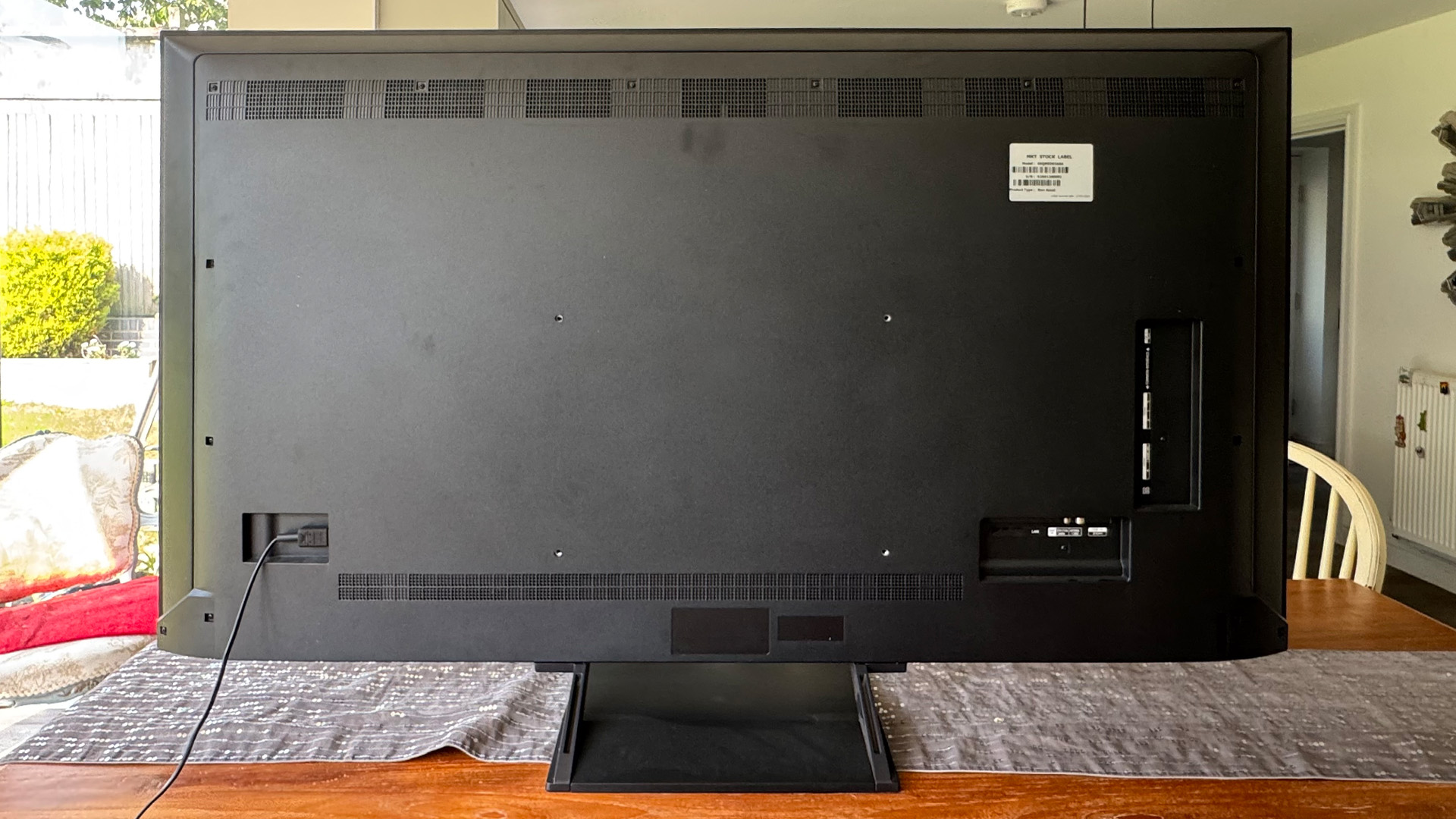 LG 65QNED93 LCD TV on wooden dining table, rear of set