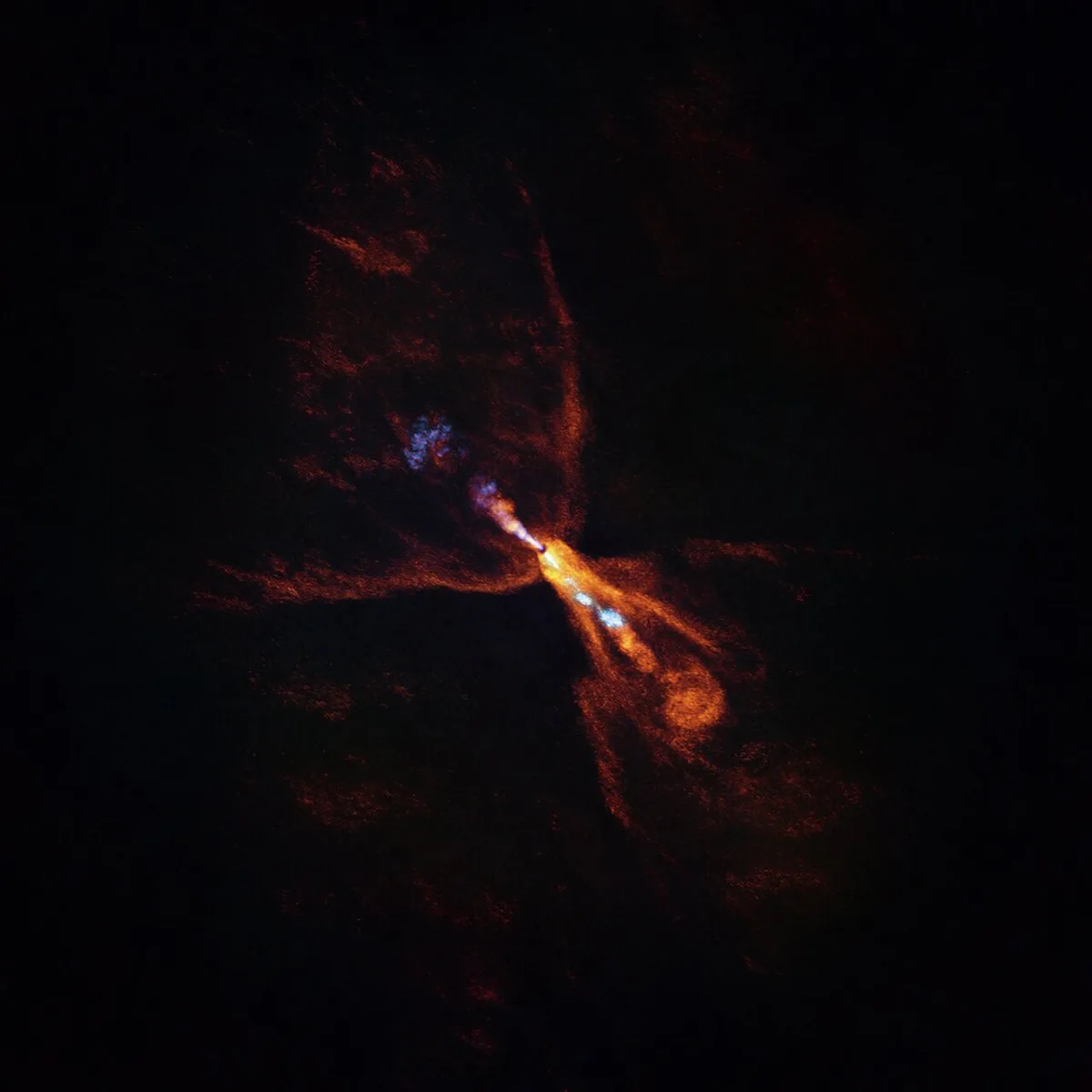 HOPS-315 is a baby star where astronomers have observed evidence for the earliest stages of planet formation. The image was taken with the Atacama Large Millimeter/submillimeter Array (ALMA). Orange we see the distribution of carbon monoxide, blowing away from the star. Blue is a narrow jet of silicon monoxide, also beaming away from the star. Credit: ALMA(ESO/NAOJ/NRAO)/M. McClure et al.