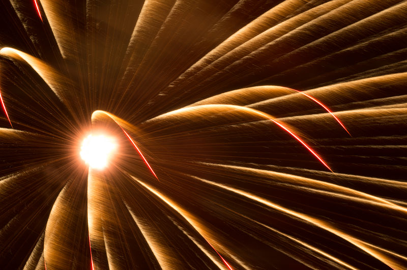 A glowing ball shooting sparks on a dark background