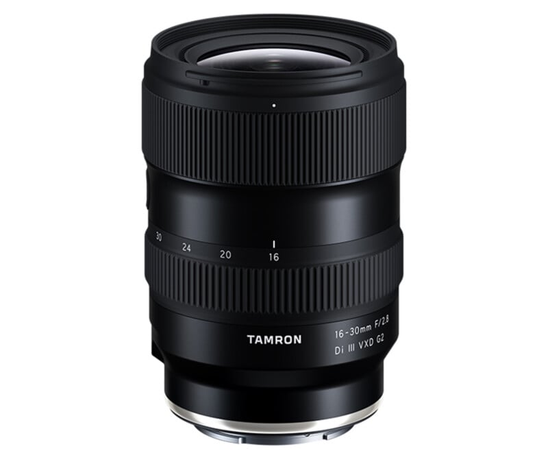A black Tamron camera lens with a zoom range of 16-30mm and an aperture of f/2.8, featuring textured adjustment rings and labeled as Di III VXD G2. The lens is standing upright on a white background.